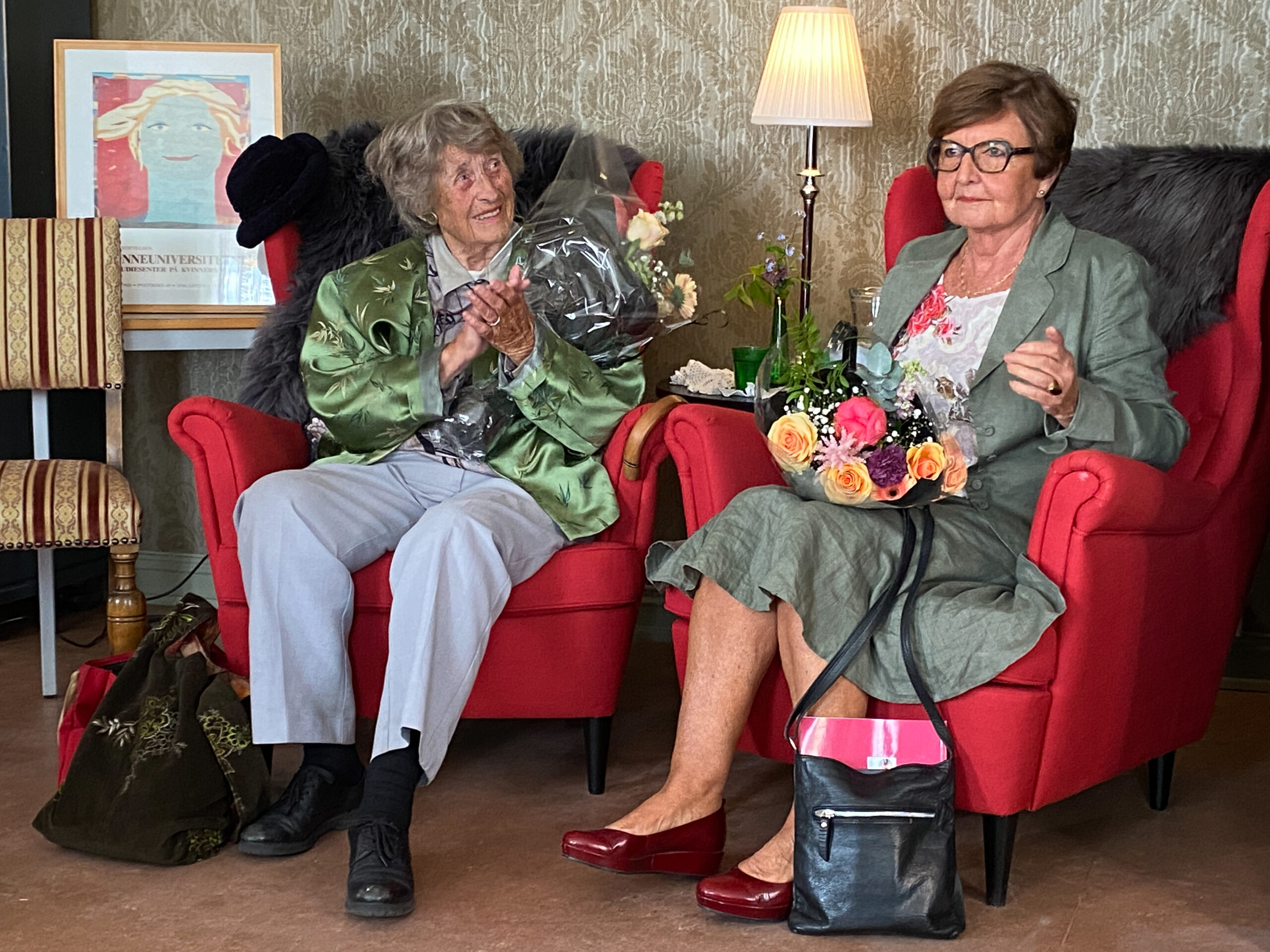 Berit Ås og Ingrid Morken sitter i hvert sin ørelappstol.