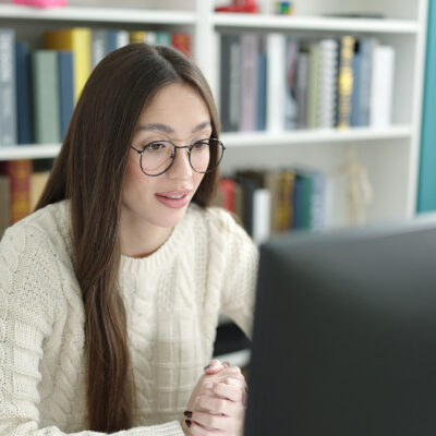 En ung lærer sitter foran en PC.