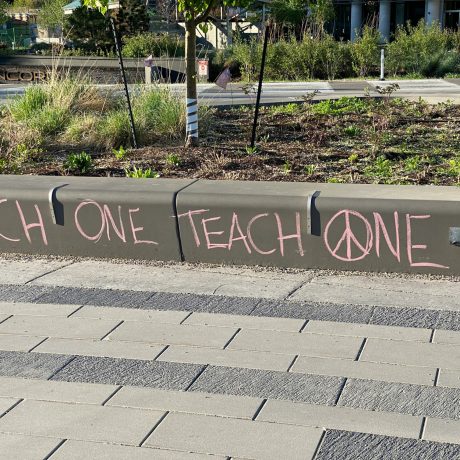 Fortauskant hvor noen har skrevet teksten Each one, teach one.